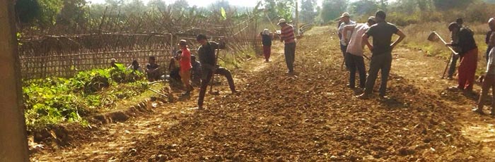 Villagers carve out the road to development